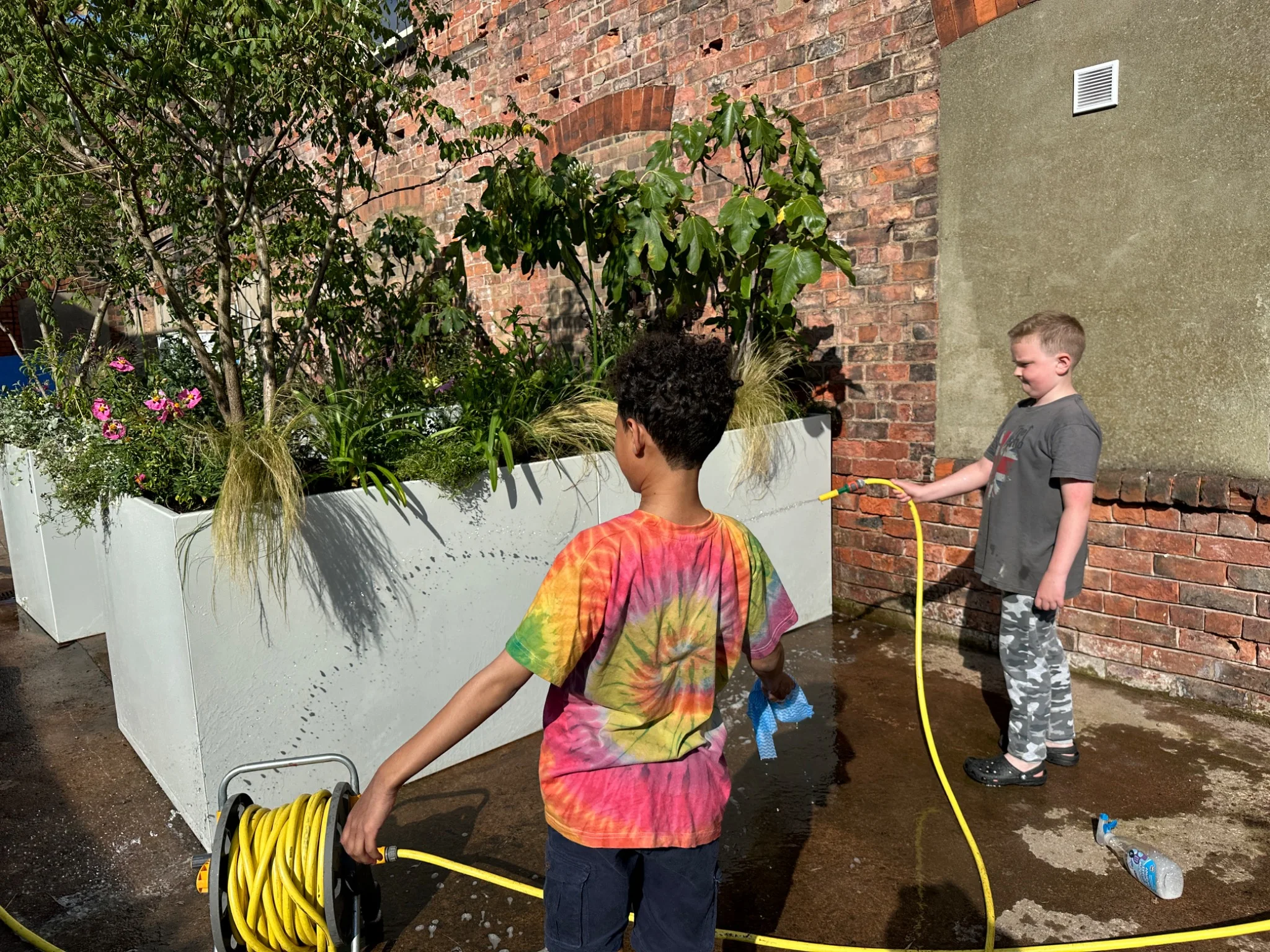 Young people helping to care for The Anywhere Courtyard