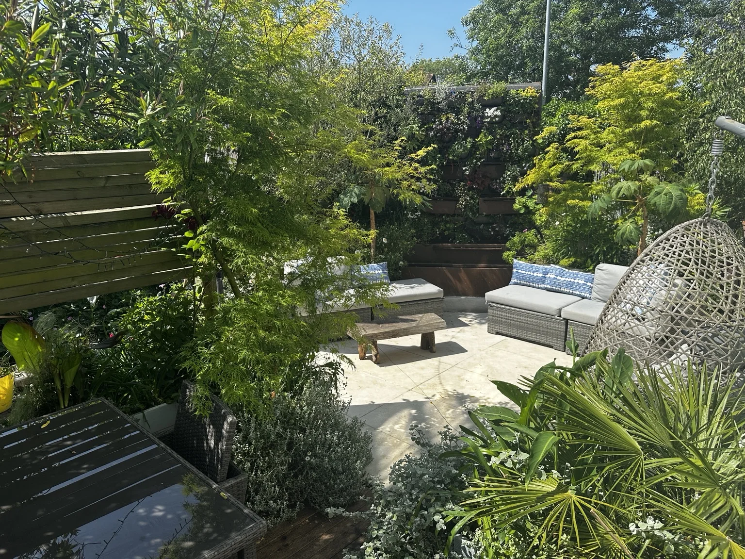 Mediterranean-inspired private garden with layered planting and outdoor seating